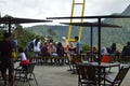 visitors to a cafe are resting and enjoying the view of the green hills in the Sembalun area of Ã¢â¬â¹Ã¢â¬â¹the Mount Rinjani